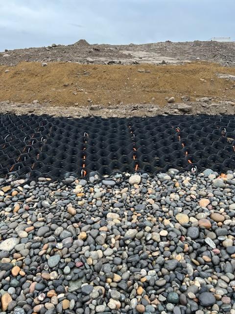 A bed of rocks is added to line Clover Island's shoreline to control erosion during a 2021 to 2022 restoration project.