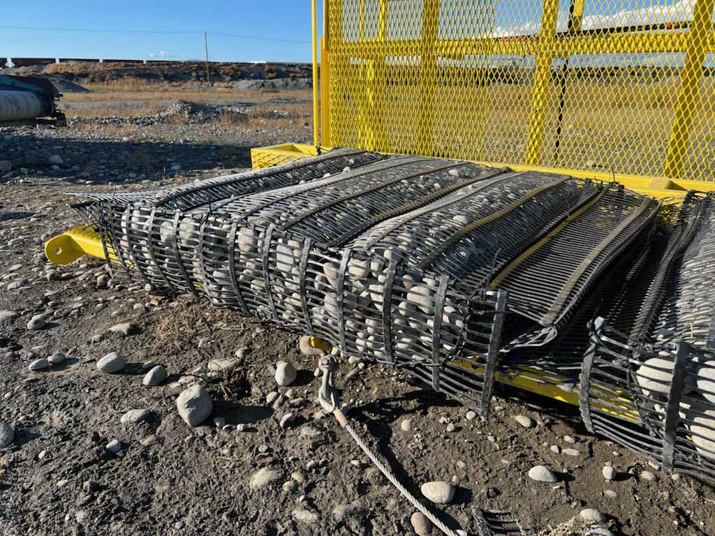 A rock-filled rectangular steel cage. The cages will line the shoreline to control shoreline erosion.