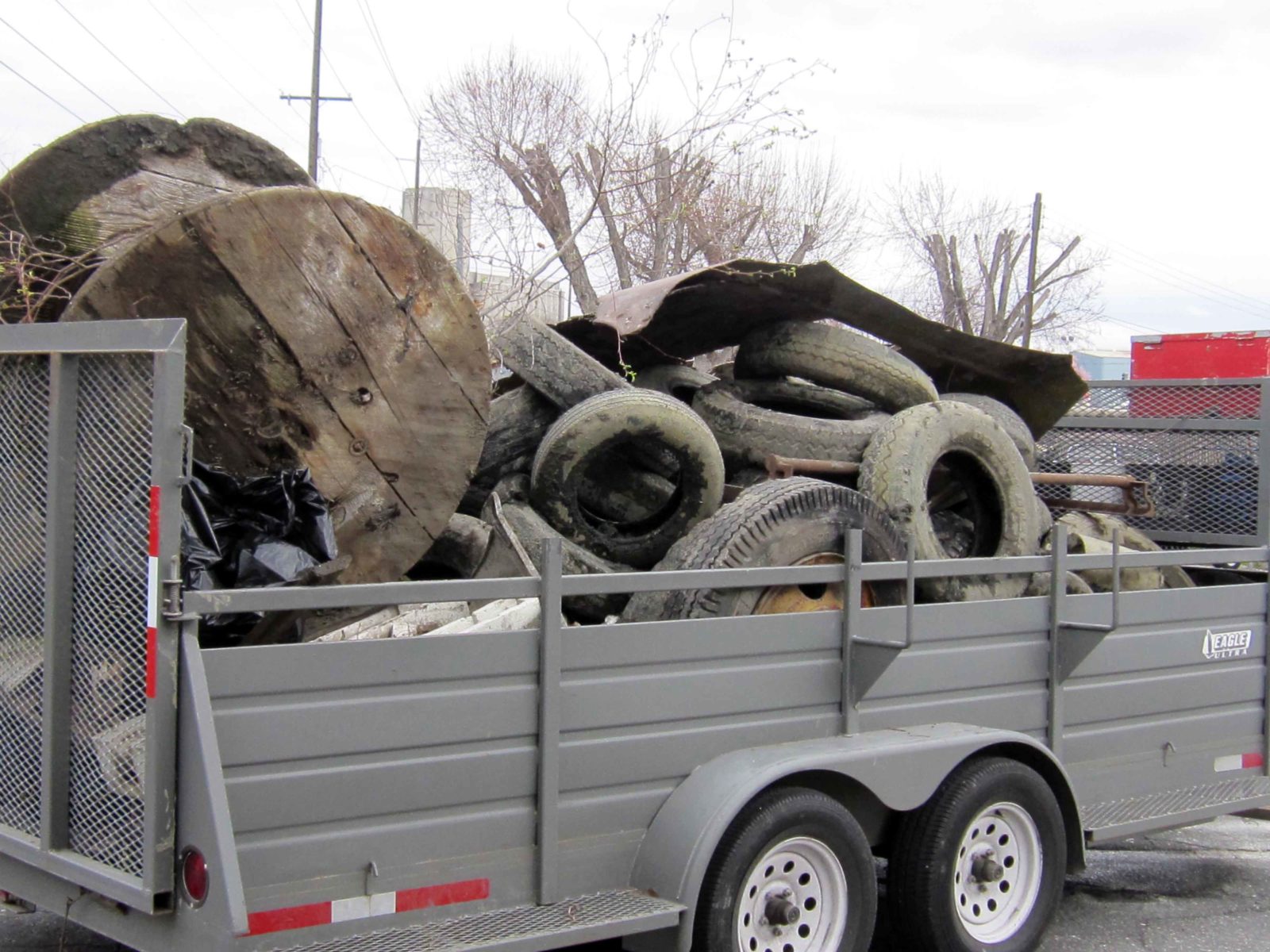 Piles of debris from the clean-up work loaded in a trailer.