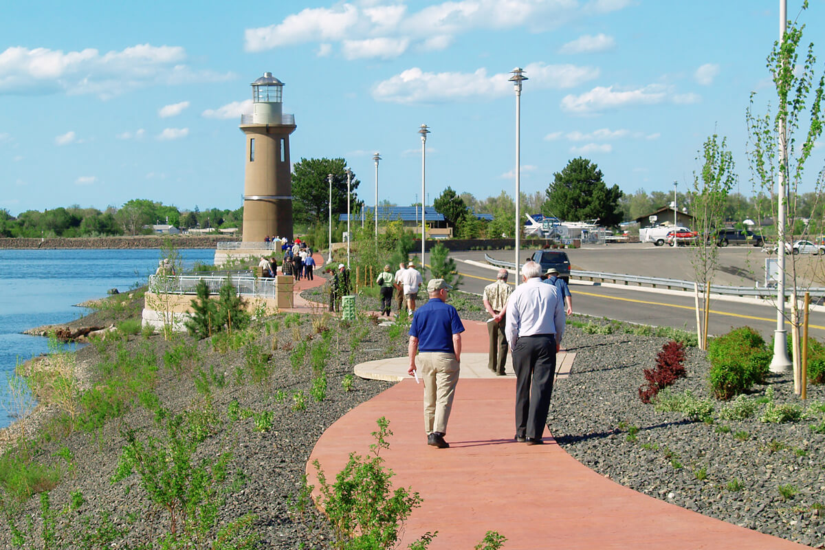 Community members strolling on a Clover Island pathway.
