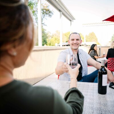 Guests clink glasses at the Bartholomew Winery's Columbia Gardens tasting room patio.