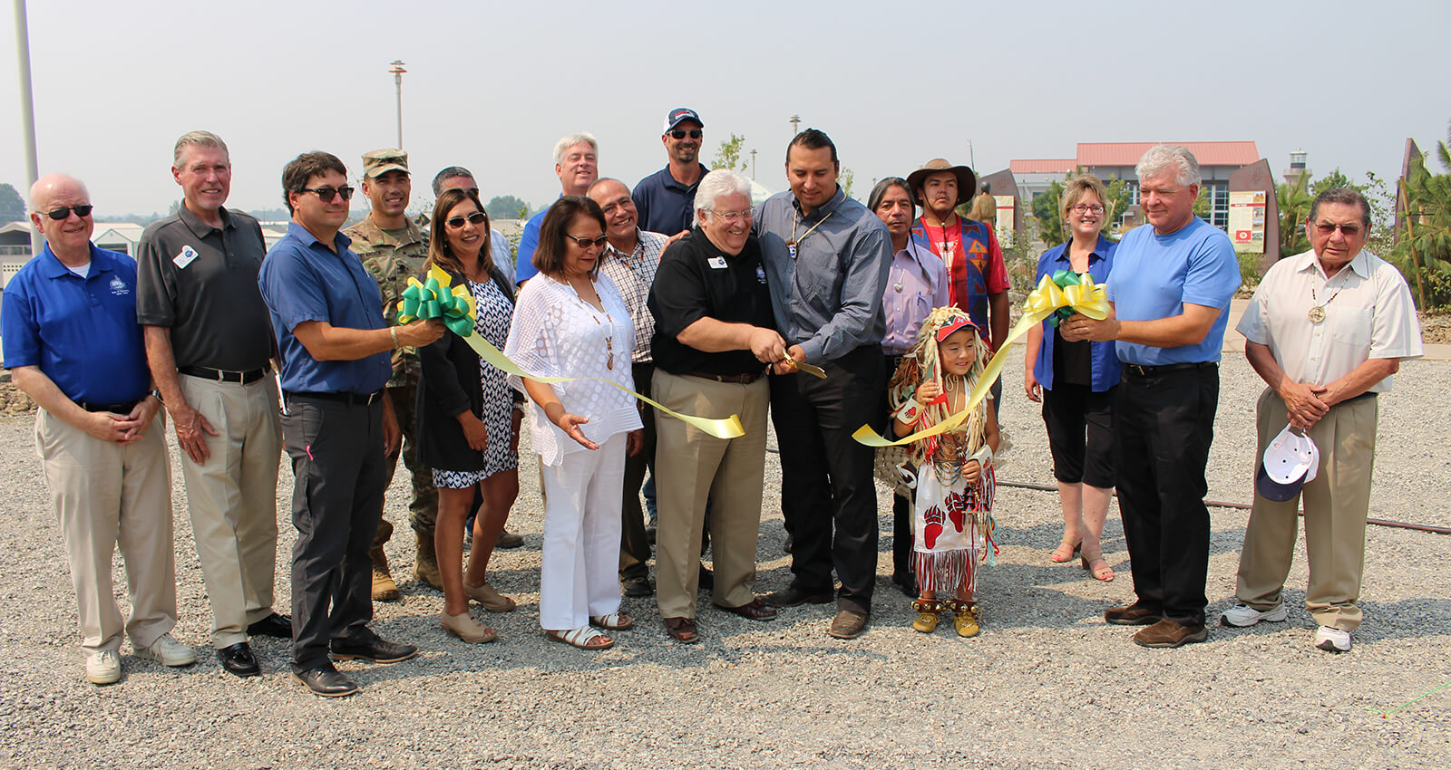 Port and Tribal officials cut ceremonial ribbon celebrating artwork.