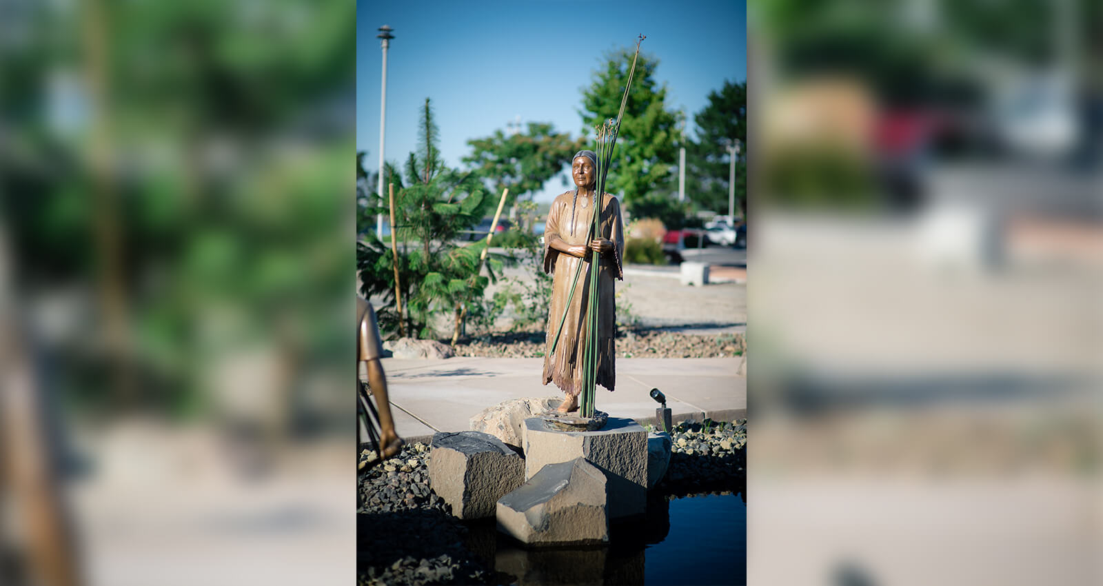The Gathering Place Elder Woman sculpture holding tule reeds.