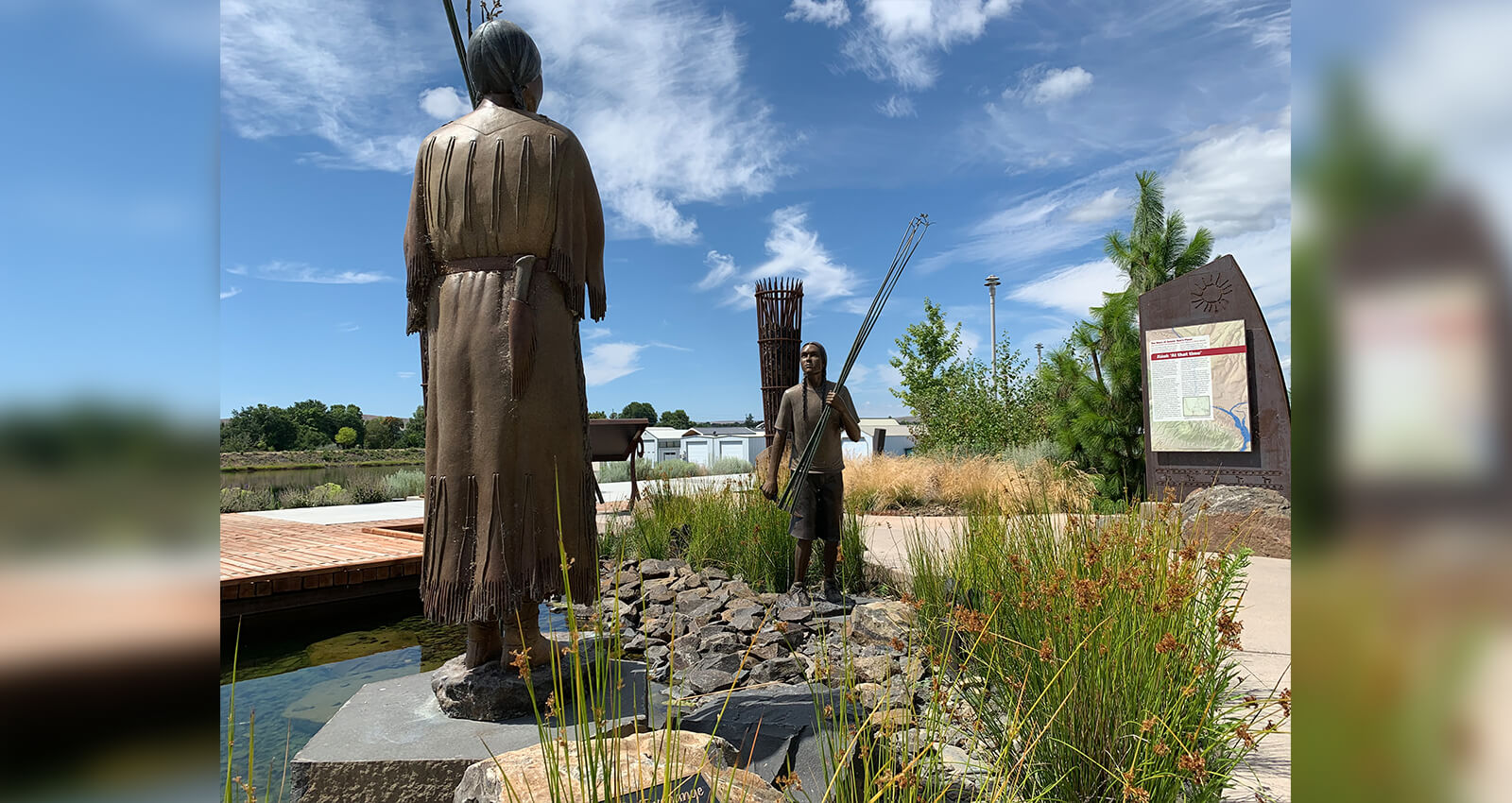 Two bronze statues with Tule reeds at The Gathering Place.